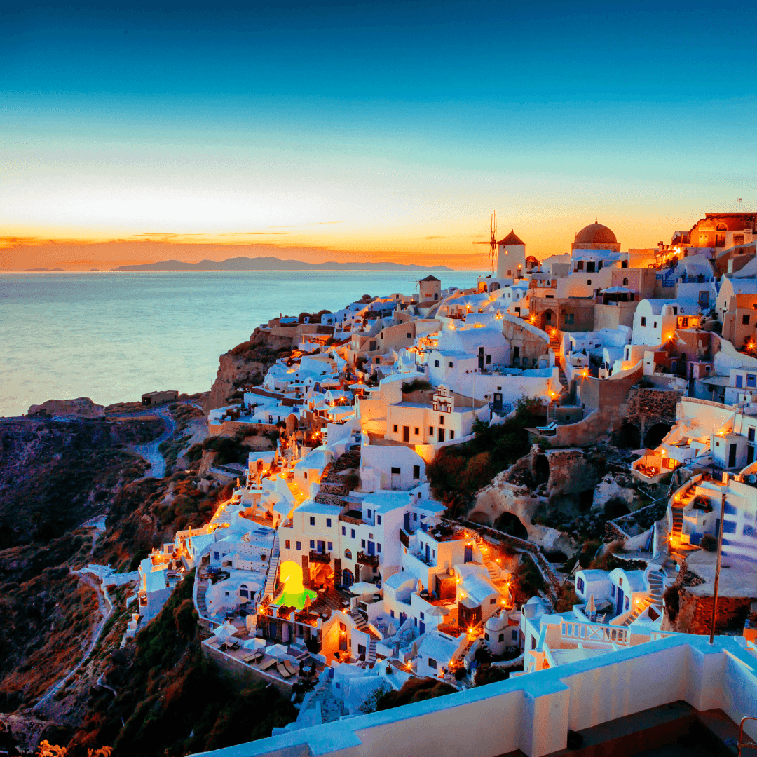 Witness the iconic sunsets of Santorini as the sun dips below the Aegean Sea, painting the sky in hues of orange and pink, complementing the whitewashed houses perched on volcanic cliffs.