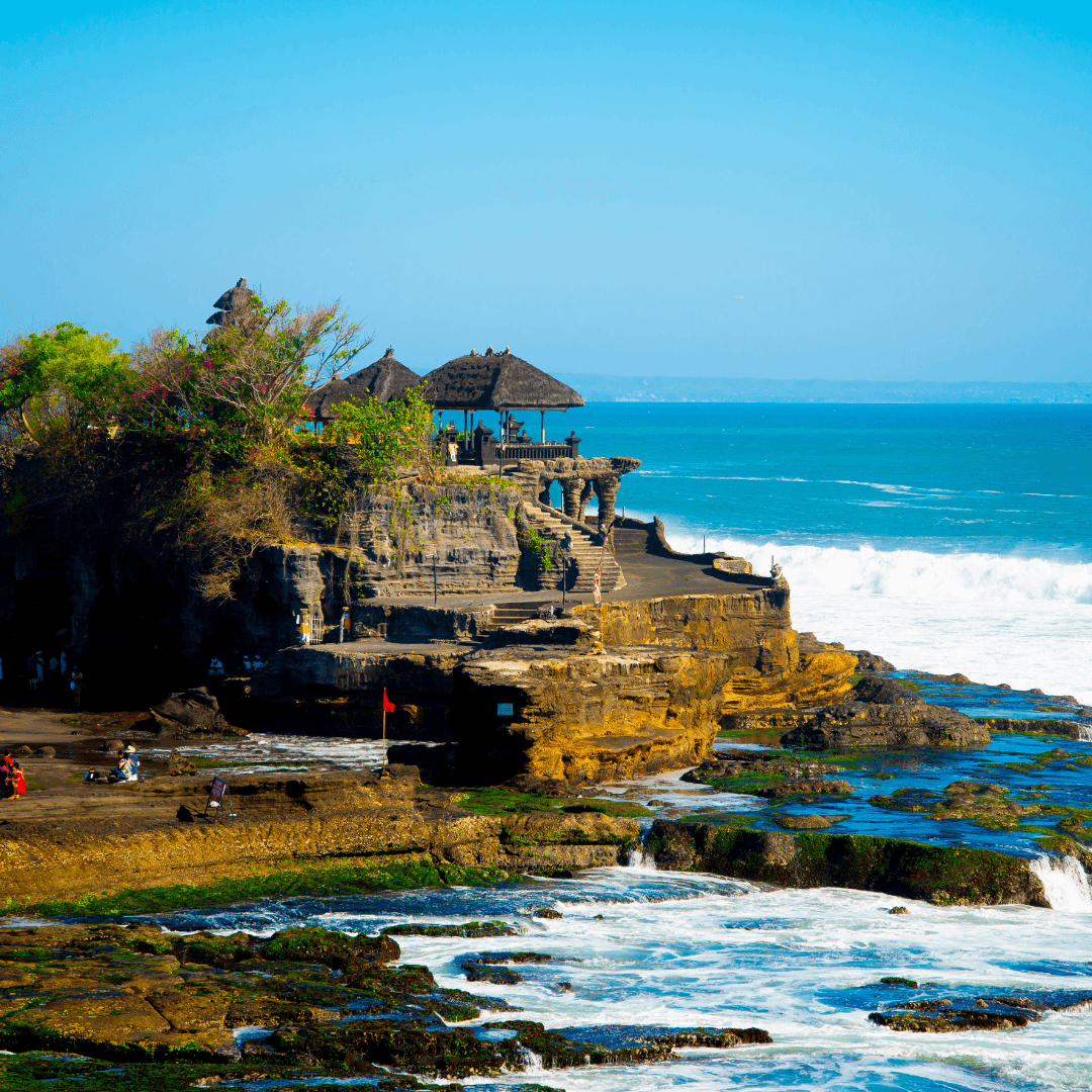 Experience the iconic Uluwatu Temple, perched dramatically on a cliff with panoramic views of the Indian Ocean. Witness a stunning sunset that paints the sky, creating a breathtaking backdrop for this architectural marvel.